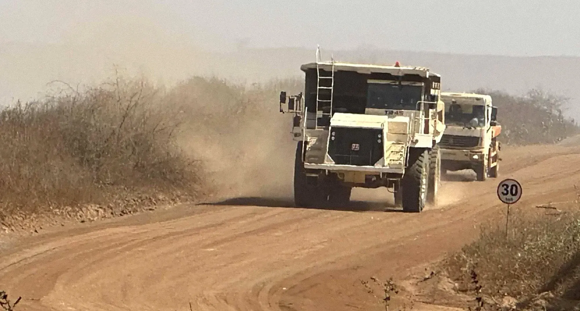 Haul trucks on a dusty mine haul road in Southern Africa